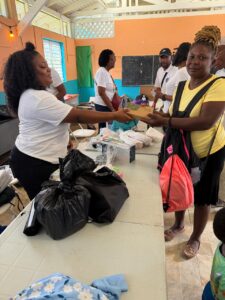 Volunteers distribute Unite to Light solar chargers in Bunkers Hill, Jamaica.